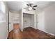 Bedroom with hardwood flooring and neutral walls featuring closet and access to other rooms at 503 N Boyce St, Gastonia, NC 28052