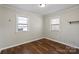 Well-lit bedroom featuring wood floors, two windows, and a calming neutral color scheme at 503 N Boyce St, Gastonia, NC 28052