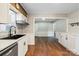 Modern kitchen with white cabinets, stainless steel appliances, wood flooring and light at 503 N Boyce St, Gastonia, NC 28052