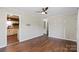 Open living room with wood floors, a ceiling fan, and an entrance to kitchen at 503 N Boyce St, Gastonia, NC 28052