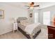 Bright bedroom with floral bedding, ceiling fan, and plenty of natural light at 509 N Graham St # 1G, Charlotte, NC 28202