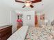 Spacious bedroom with floral bedding, ceiling fan, and en-suite bathroom access at 509 N Graham St # 1G, Charlotte, NC 28202