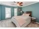 Serene bedroom with light walls, a ceiling fan, and a view of a window with shutters at 509 N Graham St # 1G, Charlotte, NC 28202