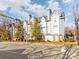 Three-story building exterior with a street view and landscaping at 509 N Graham St # 1G, Charlotte, NC 28202