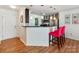 Modern kitchen with breakfast bar and pink stools at 509 N Graham St # 1G, Charlotte, NC 28202