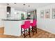 Modern kitchen with a breakfast bar and pink stools at 509 N Graham St # 1G, Charlotte, NC 28202