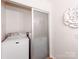 Convenient laundry closet with washer, dryer, and frosted glass sliding door at 509 N Graham St # 1G, Charlotte, NC 28202