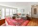 Spacious living area with gray sectional sofa and colorful rug at 509 N Graham St # 1G, Charlotte, NC 28202