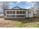 A screened porch with a white railing on the back of a house at 5204 Dellinger Cir, Cherryville, NC 28021