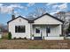 Charming single-story home with white siding, black trim and stone-accented porch at 5204 Dellinger Cir, Cherryville, NC 28021