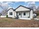 Well-maintained one-story home with white siding, black trim and stone-accented porch at 5204 Dellinger Cir, Cherryville, NC 28021