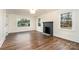 Bright living room featuring hardwood floors, fireplace, and large windows at 5204 Dellinger Cir, Cherryville, NC 28021