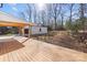 Spacious backyard with deck, detached garage, and wooded area at 5910 Grosner Pl, Charlotte, NC 28211