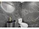 Elegant bathroom with dark marble tile and a black vessel sink at 5910 Grosner Pl, Charlotte, NC 28211