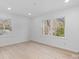 Well-lit bedroom featuring hardwood floors and multiple windows at 5910 Grosner Pl, Charlotte, NC 28211