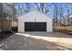 Detached garage with dark brown doors and white exterior at 5910 Grosner Pl, Charlotte, NC 28211