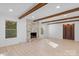 Living room with hardwood floors, exposed beams and a marble fireplace at 5910 Grosner Pl, Charlotte, NC 28211