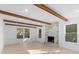 Living room with hardwood floors, exposed beams, and a marble fireplace at 5910 Grosner Pl, Charlotte, NC 28211