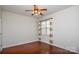 Spacious bedroom with hardwood floors and ceiling fan at 6132 Pale Moss Ln, Charlotte, NC 28269