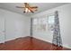 Hardwood floor bedroom with window, blinds and ceiling fan at 6132 Pale Moss Ln, Charlotte, NC 28269