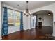 Bright dining room with hardwood floors and a view of the living room at 6132 Pale Moss Ln, Charlotte, NC 28269