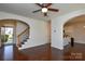 Spacious entryway with hardwood floors, an open staircase, and views into the kitchen at 6132 Pale Moss Ln, Charlotte, NC 28269