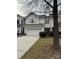 Two-story townhome with attached garage and tree in foreground at 6132 Pale Moss Ln, Charlotte, NC 28269