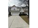 Two-story townhome with attached garage and landscaped front yard at 6132 Pale Moss Ln, Charlotte, NC 28269