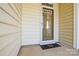 Front door entry with glass storm door and doormat at 6132 Pale Moss Ln, Charlotte, NC 28269