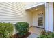 Inviting front door entry with glass storm door and landscaping at 6132 Pale Moss Ln, Charlotte, NC 28269