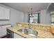 Bright kitchen boasts granite countertops, double sink, and updated appliances at 6132 Pale Moss Ln, Charlotte, NC 28269