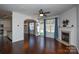 Living room with hardwood floors, fireplace, and access to kitchen at 6132 Pale Moss Ln, Charlotte, NC 28269