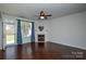 Spacious living room with hardwood floors, fireplace, and backyard access at 6132 Pale Moss Ln, Charlotte, NC 28269