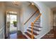 Elegant staircase with dark wood and wrought-iron railing at 6132 Pale Moss Ln, Charlotte, NC 28269