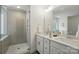 Bright bathroom featuring a double sink vanity, modern fixtures, and a glass-enclosed shower with tiled walls at 8230 Verona Rd # 80, Charlotte, NC 28213