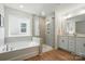 Modern bathroom with a soaking tub, glass shower, and a dual vanity at 8230 Verona Rd # 80, Charlotte, NC 28213