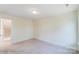 Well-lit bedroom with carpet and access to upstairs hallway at 8230 Verona Rd # 80, Charlotte, NC 28213