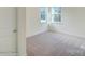 Cozy bedroom with neutral carpeting and ample natural light at 8230 Verona Rd # 80, Charlotte, NC 28213