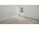 Neutral bedroom with carpet and a window at 8230 Verona Rd # 80, Charlotte, NC 28213