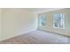 Spacious bedroom with neutral carpeting and large windows at 8230 Verona Rd # 80, Charlotte, NC 28213