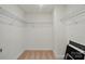Walk-in closet featuring white walls, tan carpeting, and wire shelving at 8230 Verona Rd # 80, Charlotte, NC 28213