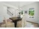Cozy dining area featuring large windows, natural lighting, and an elegant chandelier at 8230 Verona Rd # 80, Charlotte, NC 28213