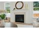 Elegant fireplace with white mantle, marble tile, and decorative accessories at 8230 Verona Rd # 80, Charlotte, NC 28213