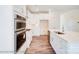 White kitchen with stainless steel appliances and large island at 8230 Verona Rd # 80, Charlotte, NC 28213