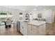 Well-lit kitchen and stainless steel appliances and an island with a stainless steel sink at 8230 Verona Rd # 80, Charlotte, NC 28213