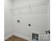 Laundry room featuring white walls, wood flooring, and utility connections at 8230 Verona Rd # 80, Charlotte, NC 28213