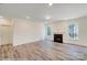 Living room with hardwood floors and fireplace, adjacent to kitchen at 8230 Verona Rd # 80, Charlotte, NC 28213