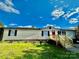 Newly renovated mobile home with a red door and landscaping at 9763 Knightbridge Dr, Concord, NC 28025