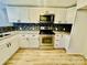 Updated kitchen featuring white cabinets and mosaic backsplash at 9763 Knightbridge Dr, Concord, NC 28025