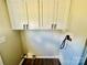 White cabinets and vinyl flooring in this laundry room at 9763 Knightbridge Dr, Concord, NC 28025